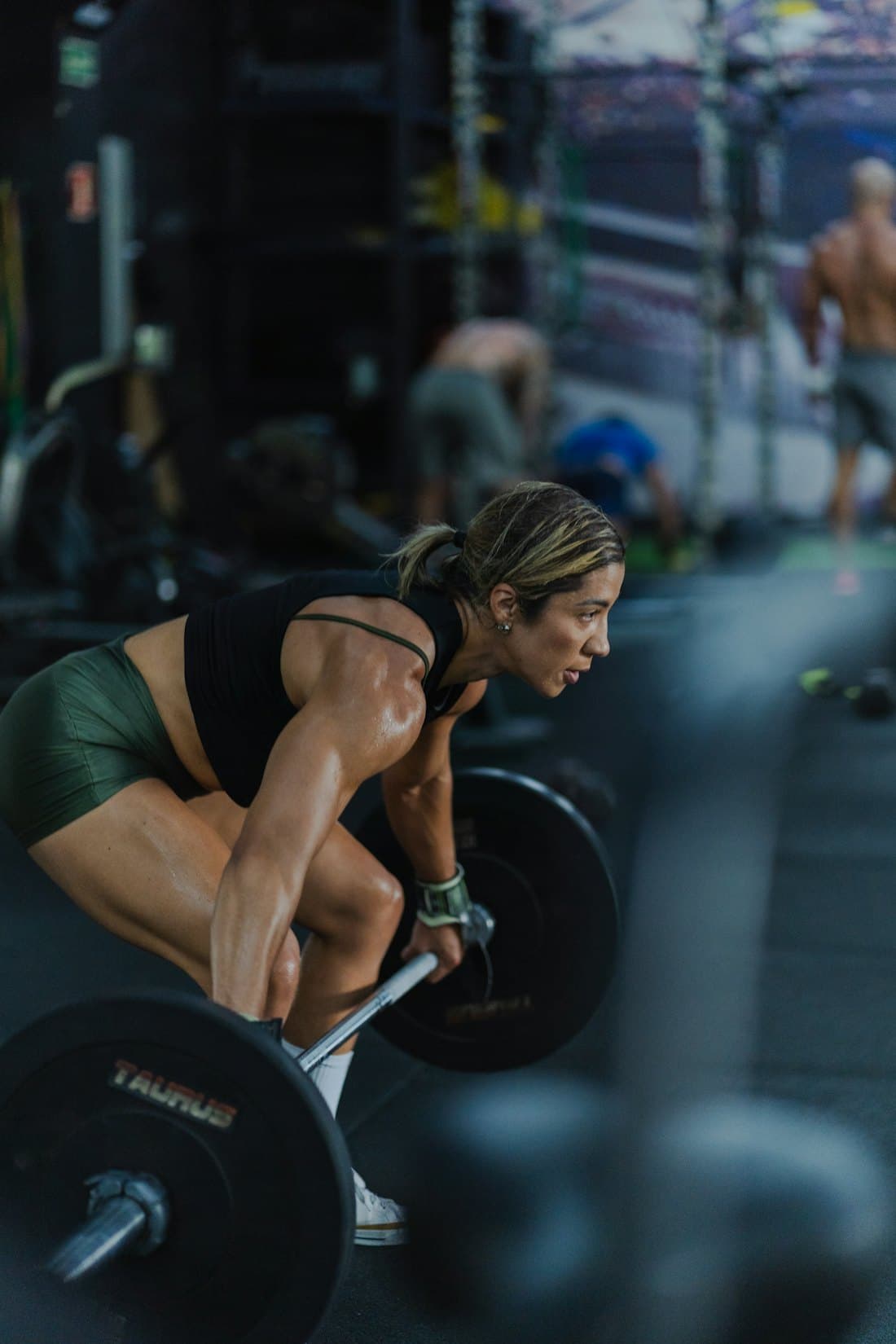 Members mid-workout on the rubber floor at a functional-fitness gym